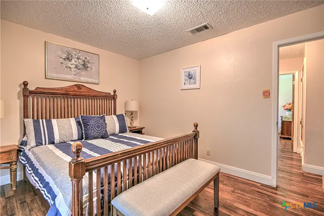 a bedroom with furniture and a window