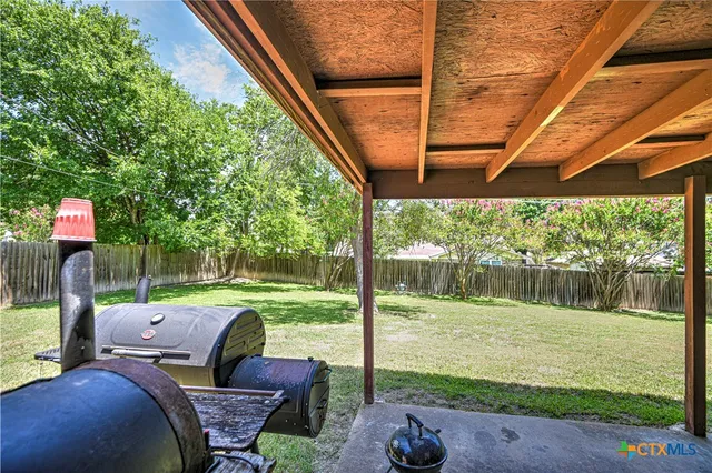 a backyard of a house with table and chairs