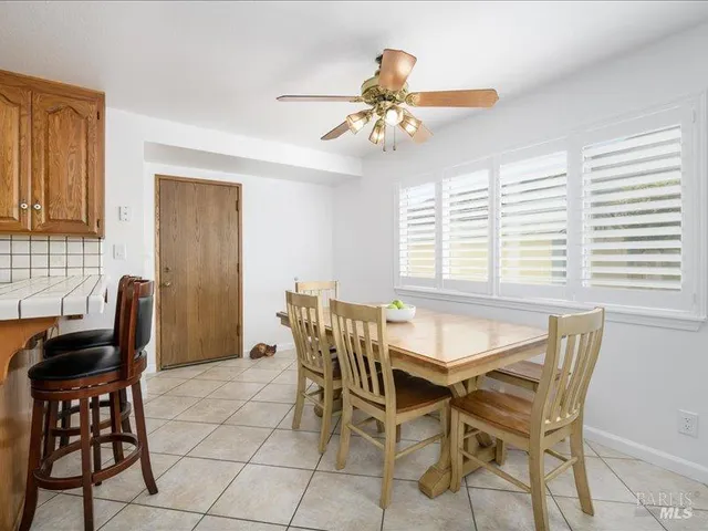 a dining room with furniture and window