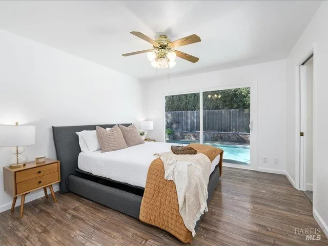 a bed sitting in a bedroom next to a window
