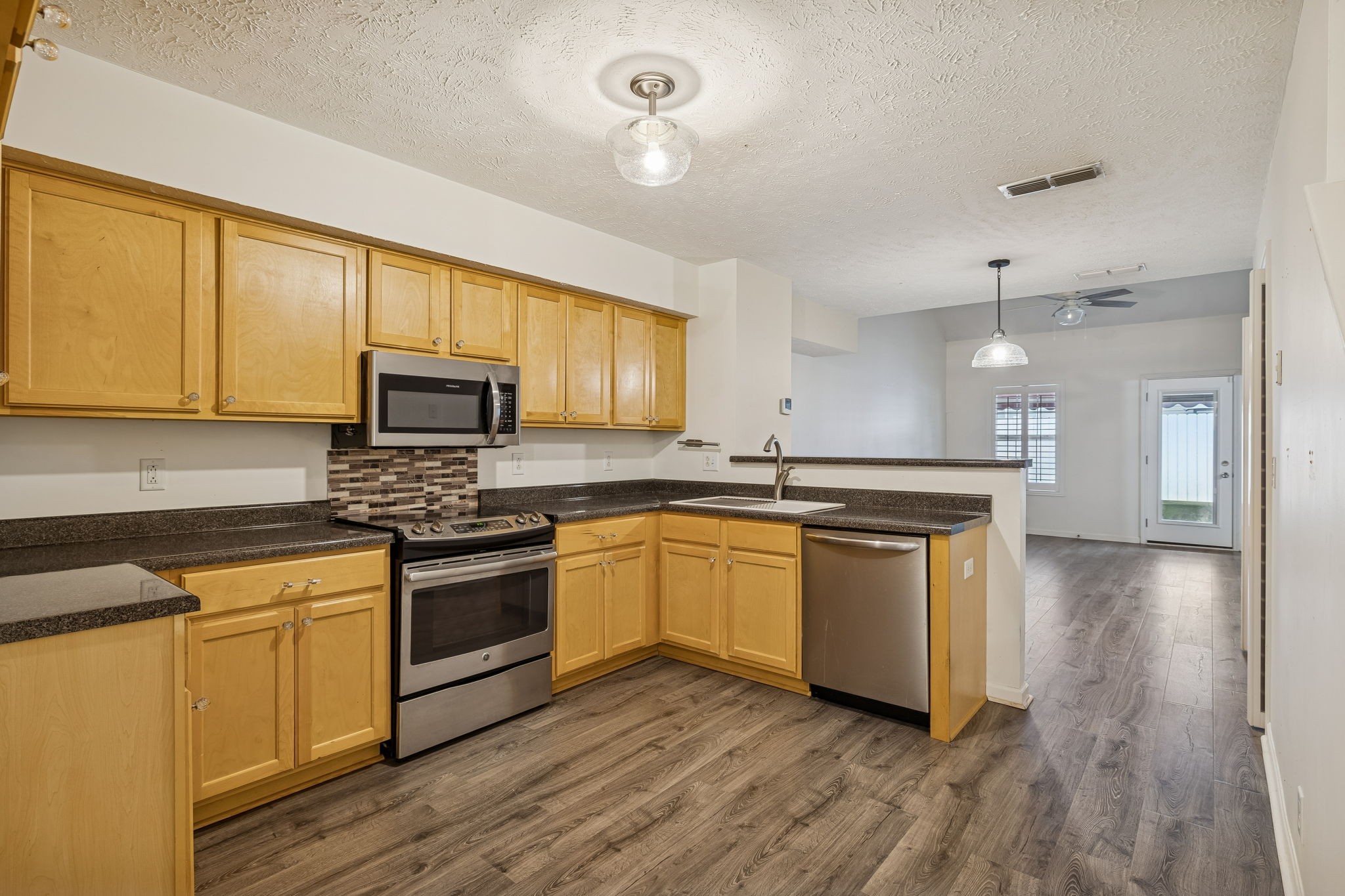 4869 Chelanie Circle Murfreesboro, TN 37129 - Photo 13 of 35 a kitchen with stainless steel appliances granite countertop a stove a sink and a microwave