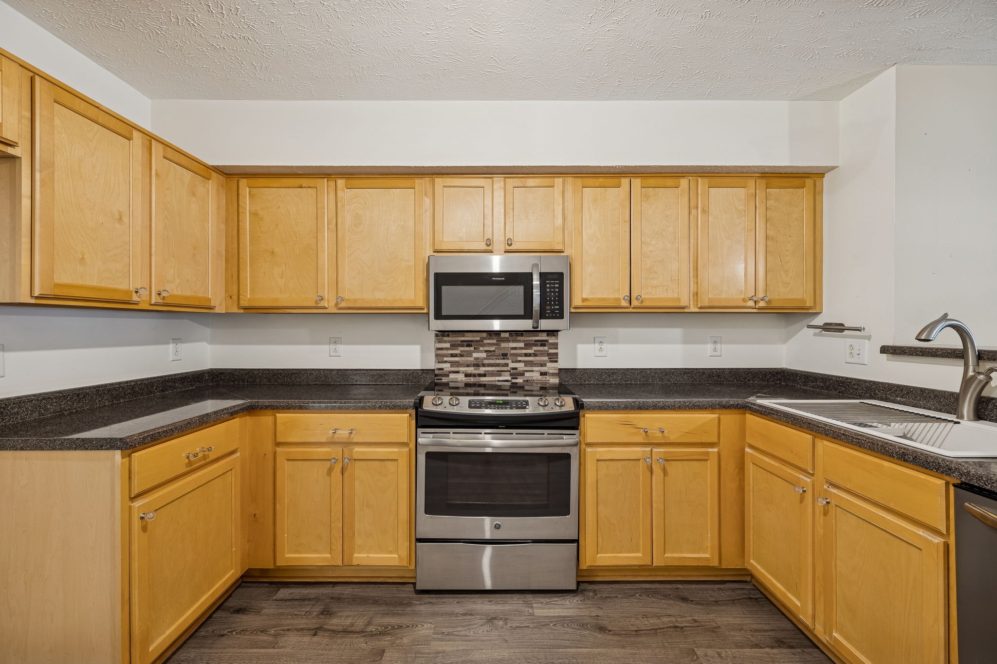 4869 Chelanie Circle Murfreesboro, TN 37129 - Photo 14 of 35 a kitchen with white cabinets and appliances