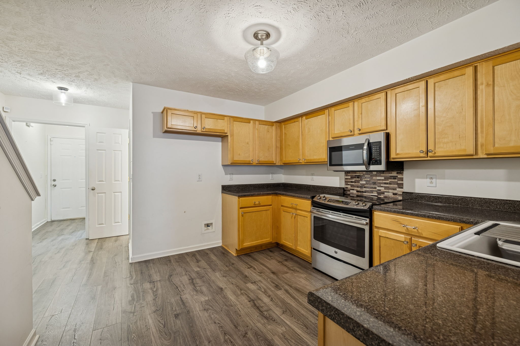 4869 Chelanie Circle Murfreesboro, TN 37129 - Photo 15 of 35 a kitchen with stainless steel appliances granite countertop a stove a sink and a microwave