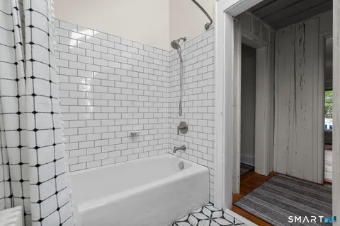 a bathroom with a bathtub and a shower
