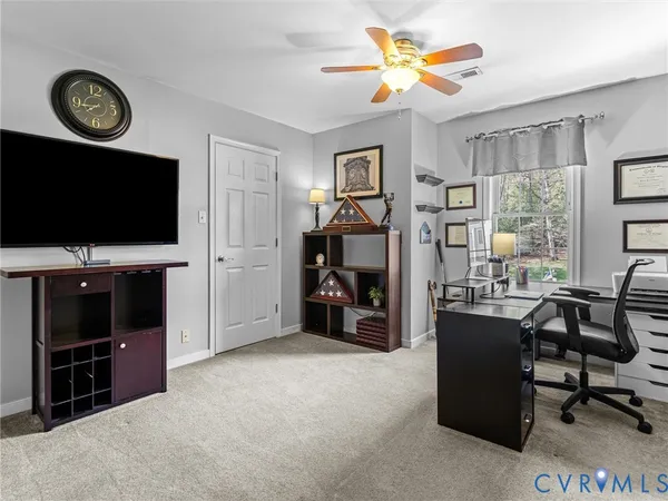 a view of a livingroom with furniture and a flat screen tv