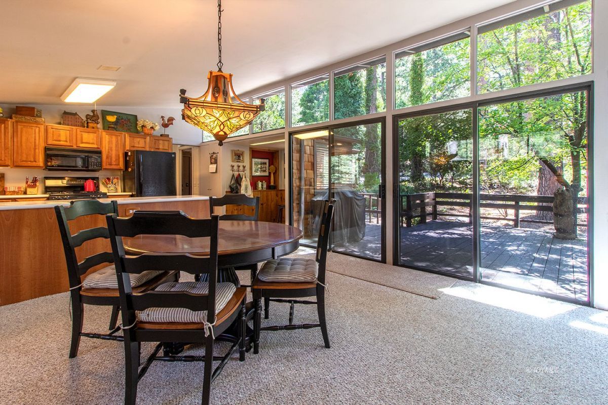 24860 Fern Valley Road Idyllwild, CA 92549 - Photo 9 of 90 a dining room with furniture and a floor to ceiling window