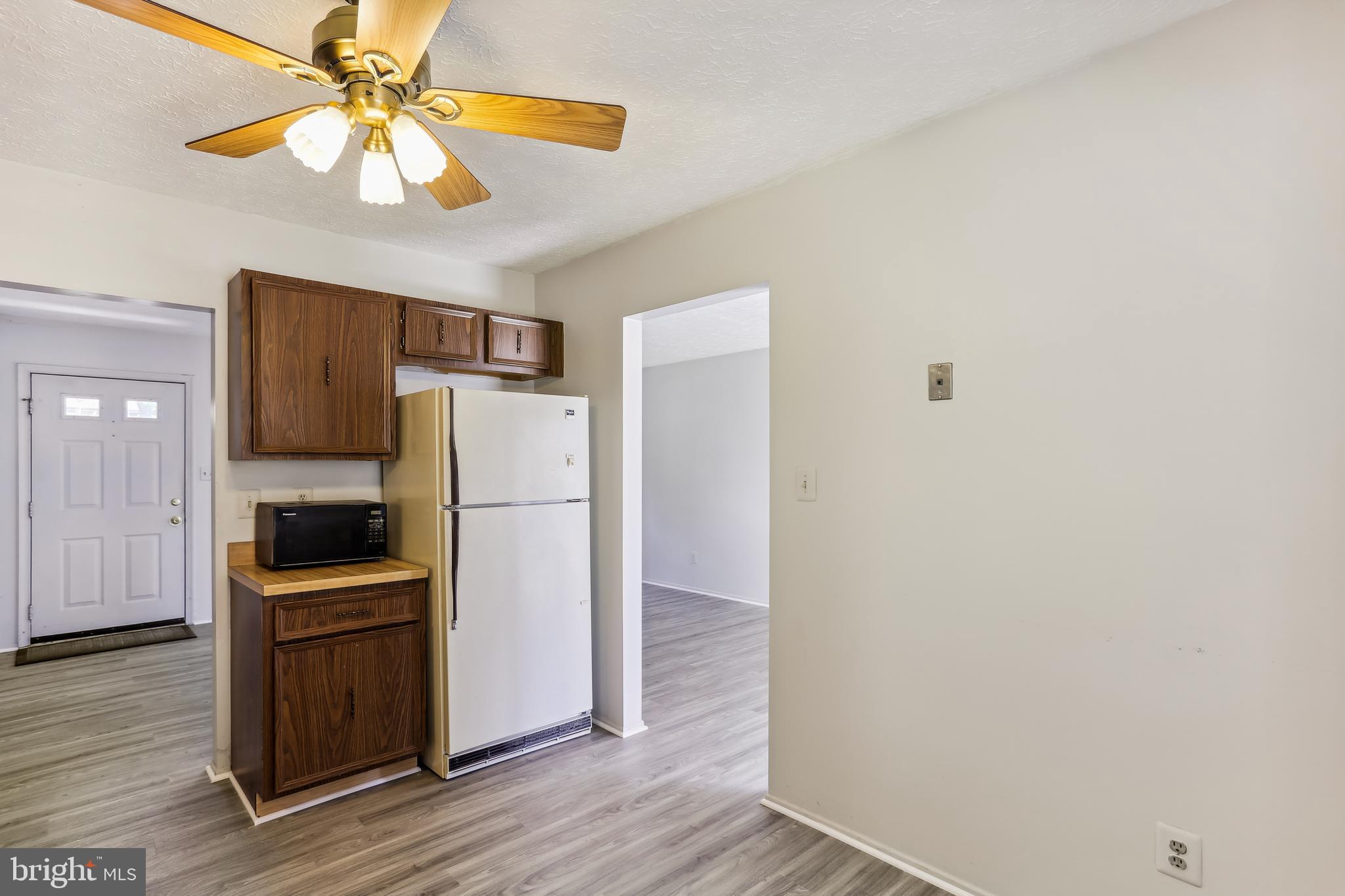 8225 Grainfield Road Severn, MD 21144 - Photo 7 of 35 a kitchen with a refrigerator a stove and a microwave