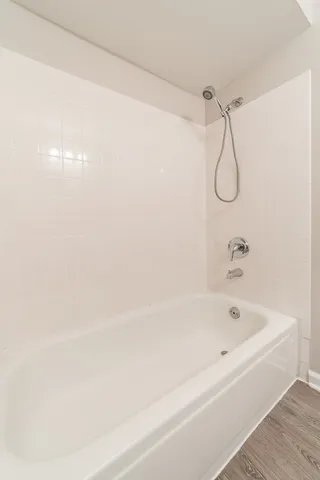a bathroom with a bath tub with a shower