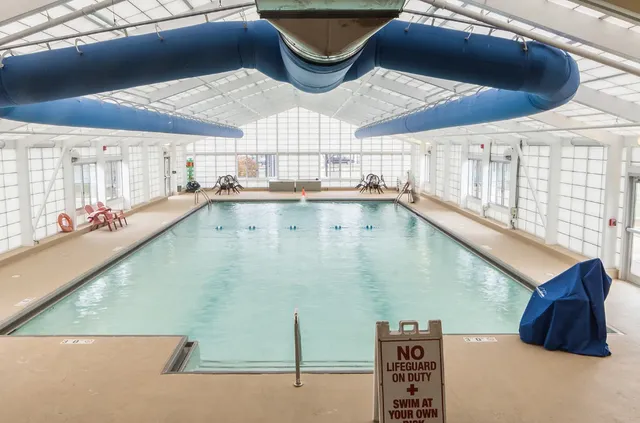 a living room with furniture a fireplace and a chandelier