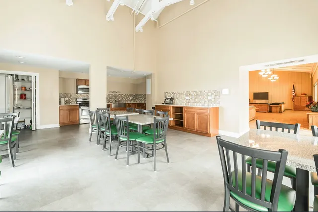 a kitchen with stainless steel appliances a white stove top oven and white cabinets