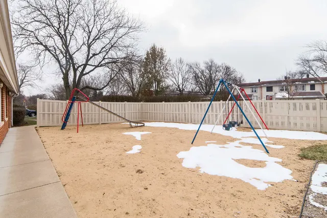 a view of a yard with a bench and trees