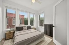 a bedroom with a large bed and a large window