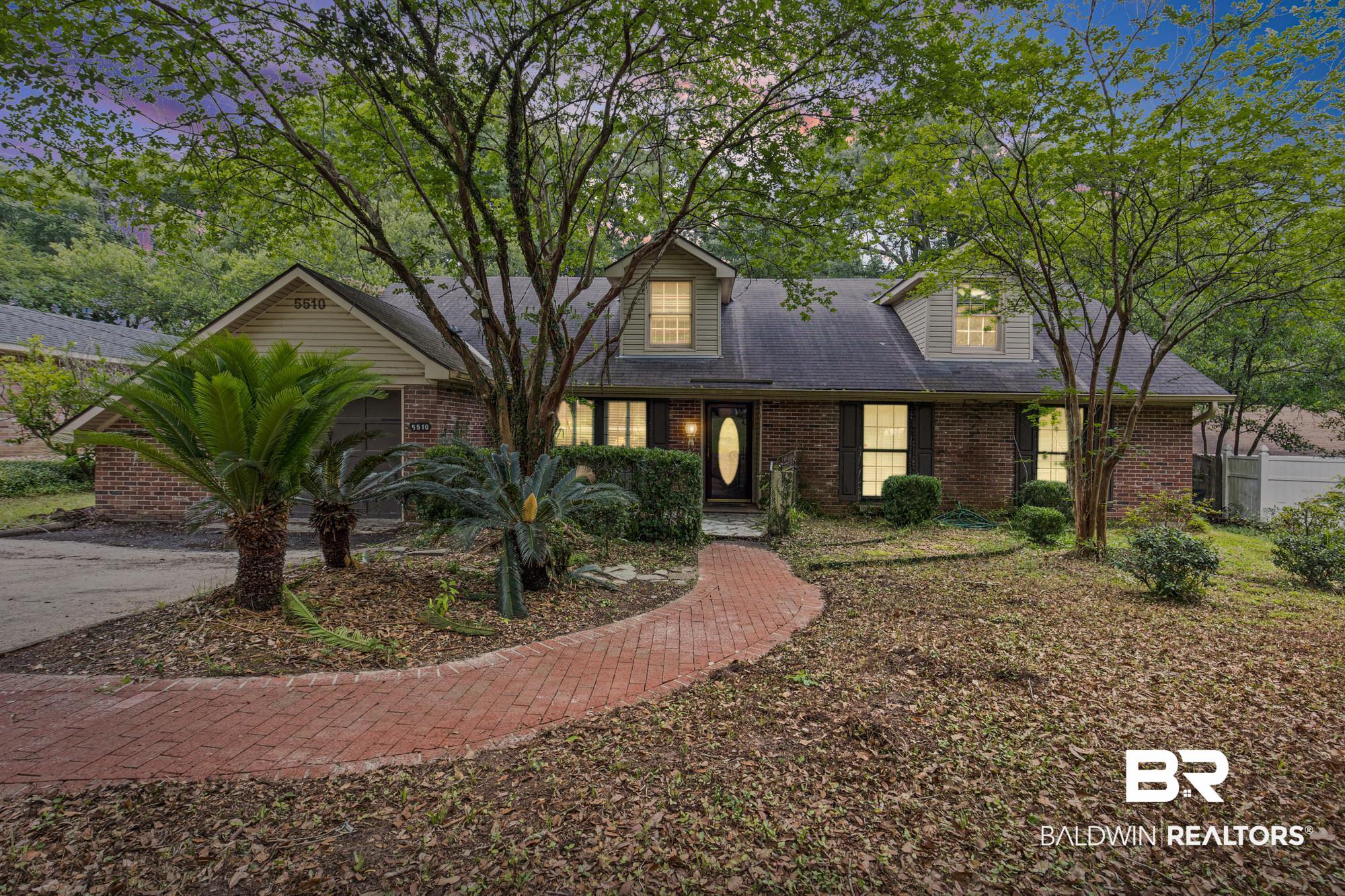 5510 Richmond Road Mobile, AL 36608 - Photo 1 of 21 Brick exterior with multiple dormer windows, featuring a prominent brick paver walkway