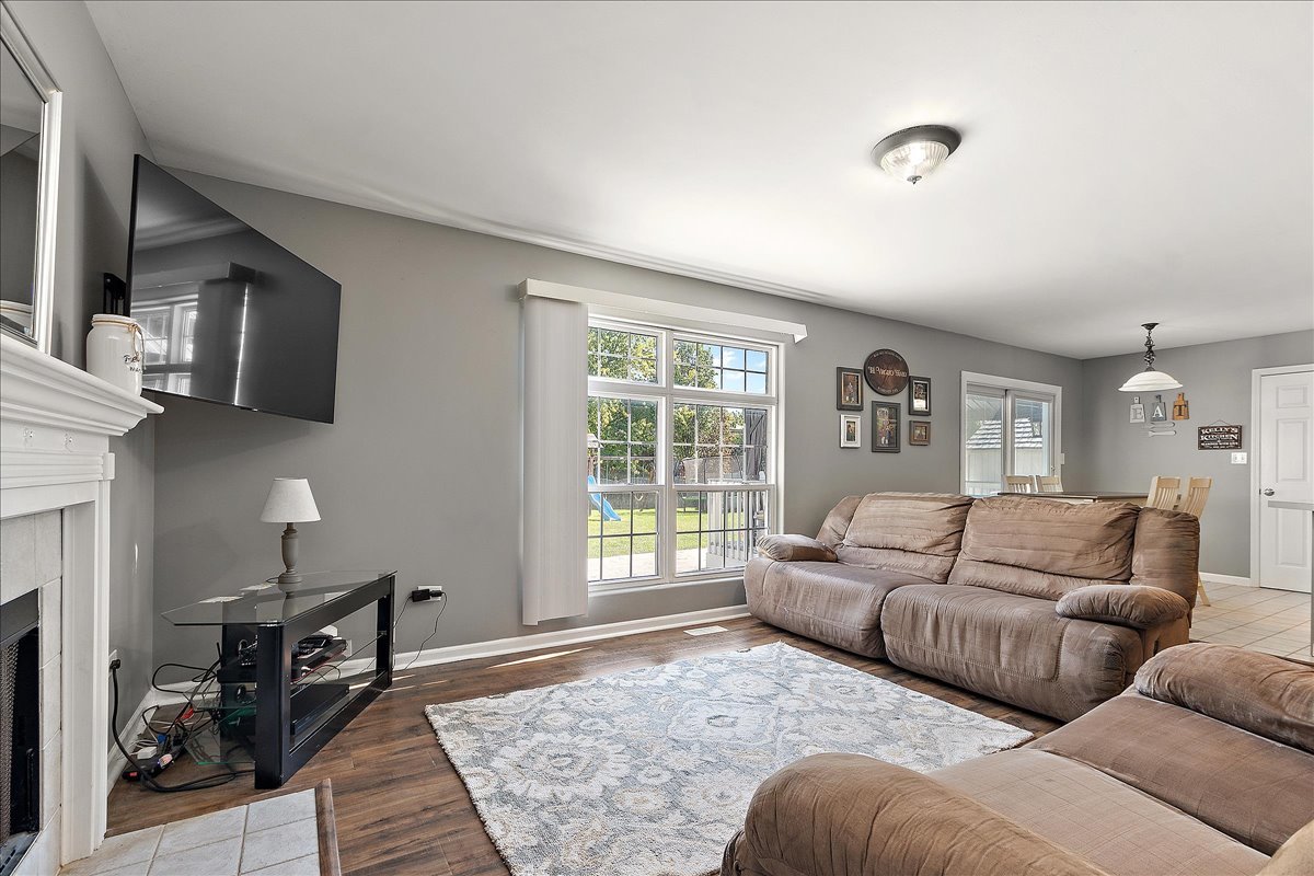 898 Meadowbrook Road Elwood, IL 60421 - Photo 12 of 30 a living room with furniture window and a fireplace