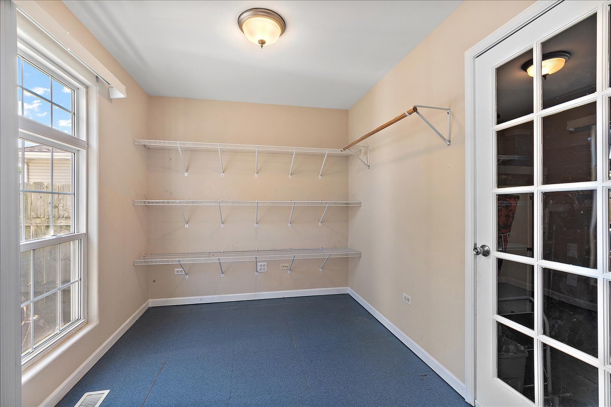 898 Meadowbrook Road Elwood, IL 60421 - Photo 15 of 30 a view of an empty room with wooden floor and windows