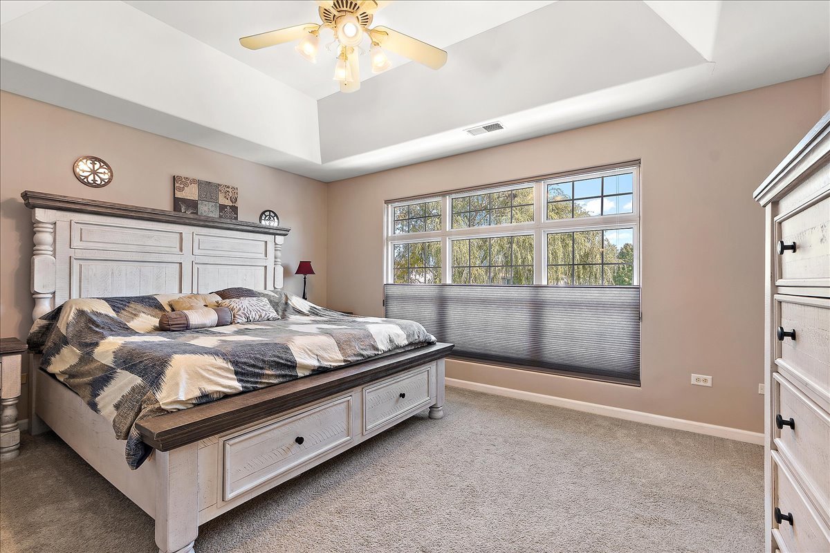 898 Meadowbrook Road Elwood, IL 60421 - Photo 16 of 30 a bed sitting in a room next to a window