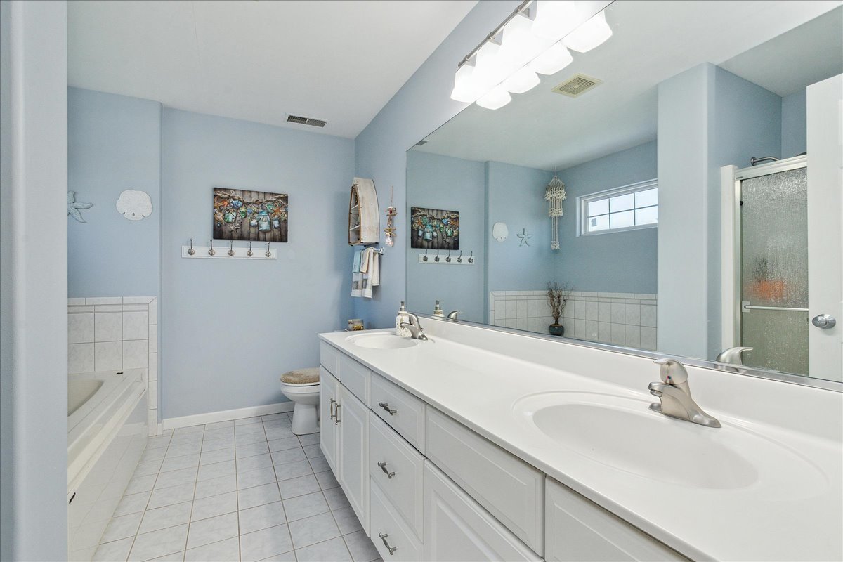 898 Meadowbrook Road Elwood, IL 60421 - Photo 18 of 30 a bathroom with a sink a toilet and a mirror