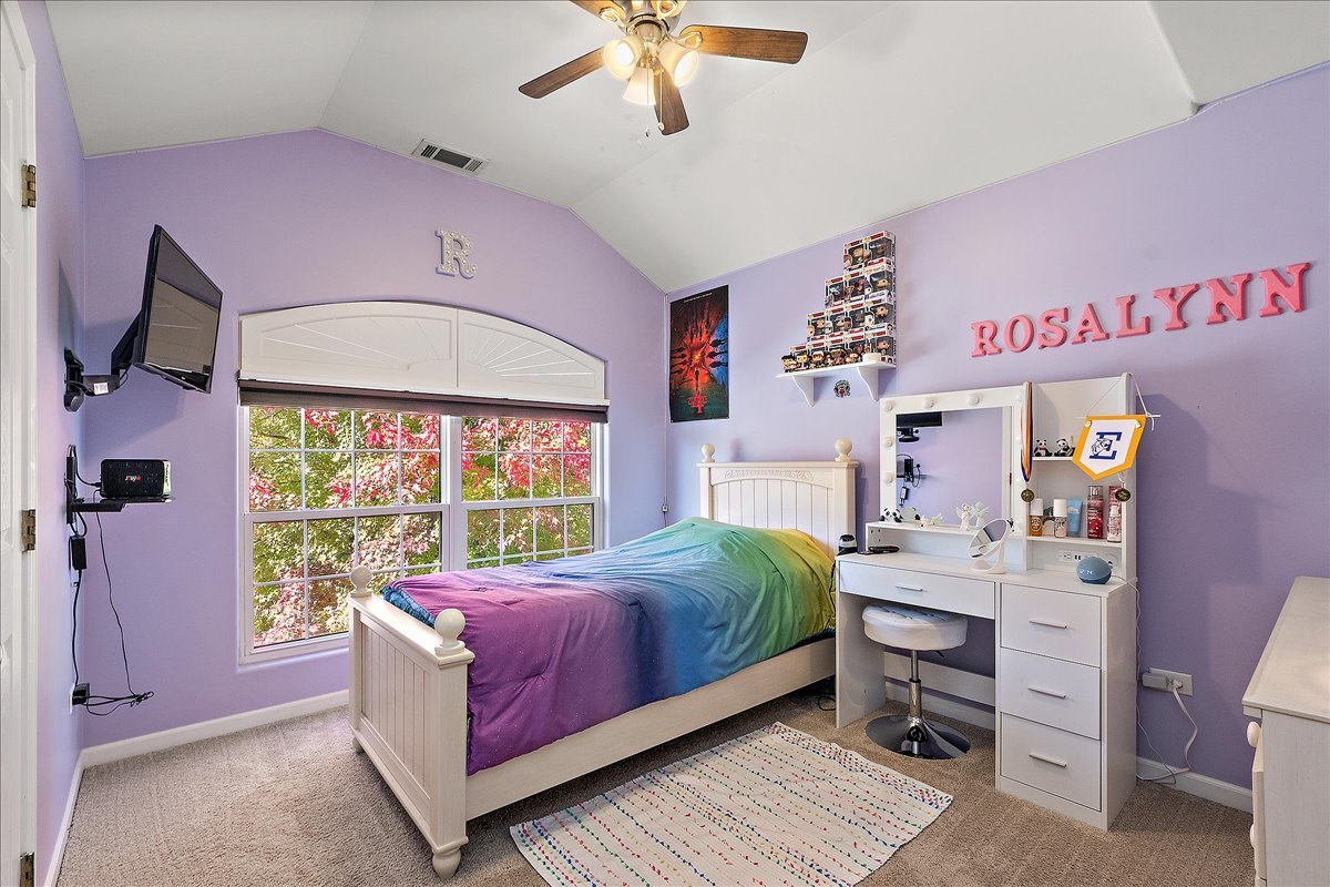 898 Meadowbrook Road Elwood, IL 60421 - Photo 20 of 30 a bedroom with a bed and a chandelier