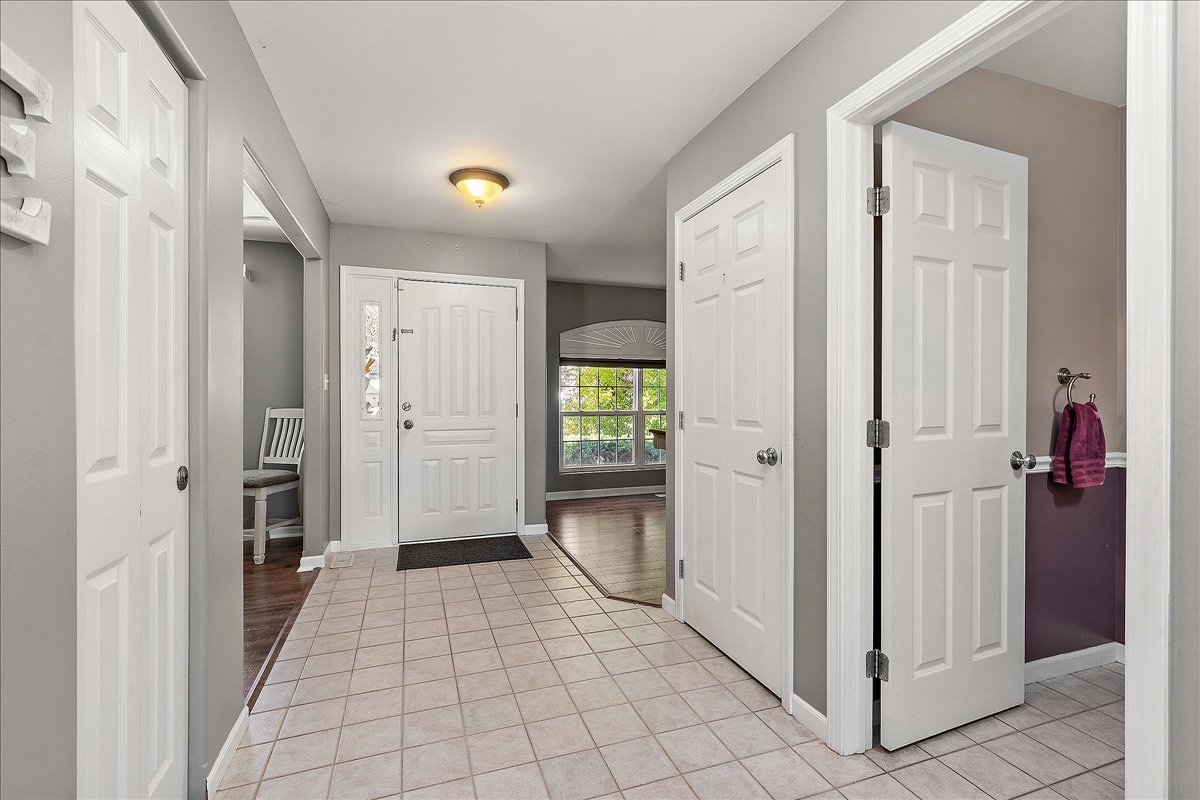 898 Meadowbrook Road Elwood, IL 60421 - Photo 2 of 30 a view of a hallway with wooden floor and closet area