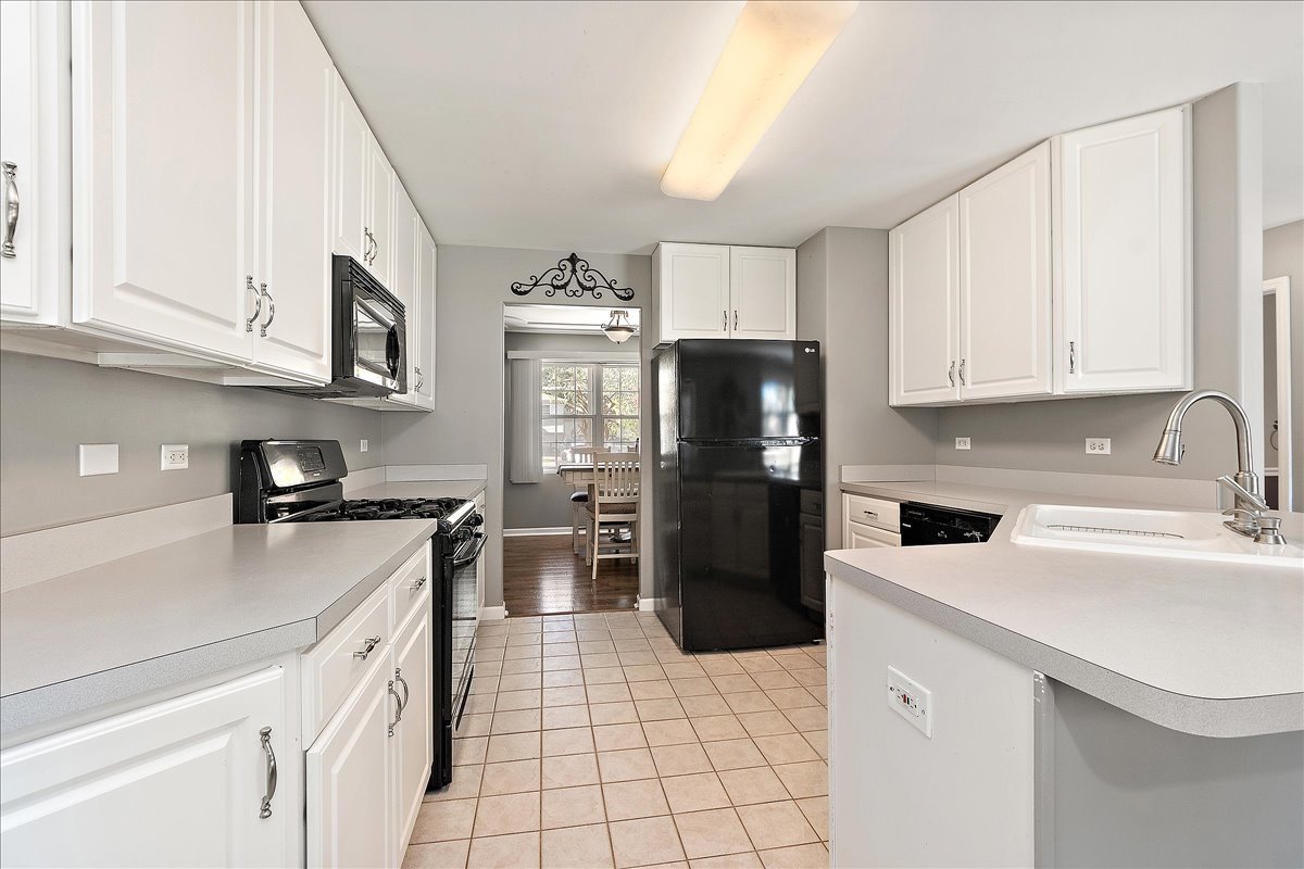898 Meadowbrook Road Elwood, IL 60421 - Photo 5 of 30 a kitchen with a sink a stove and refrigerator