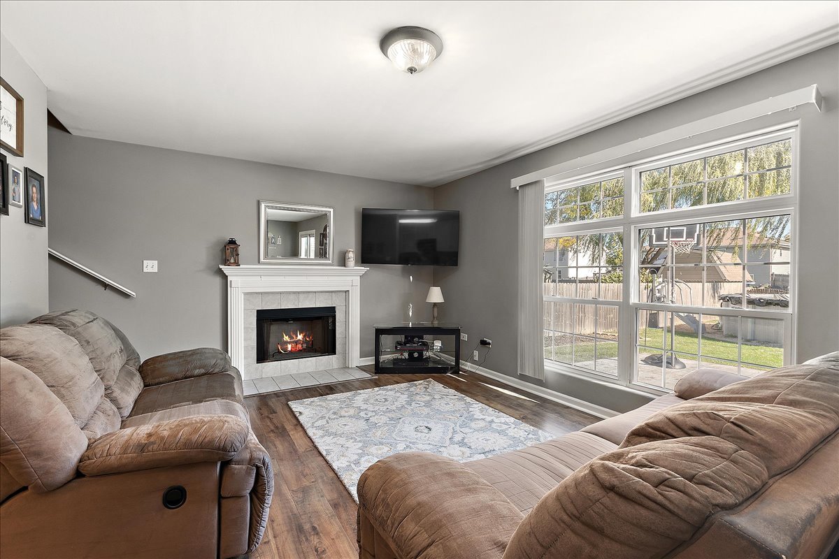 898 Meadowbrook Road Elwood, IL 60421 - Photo 10 of 30 a living room with furniture window and a fireplace