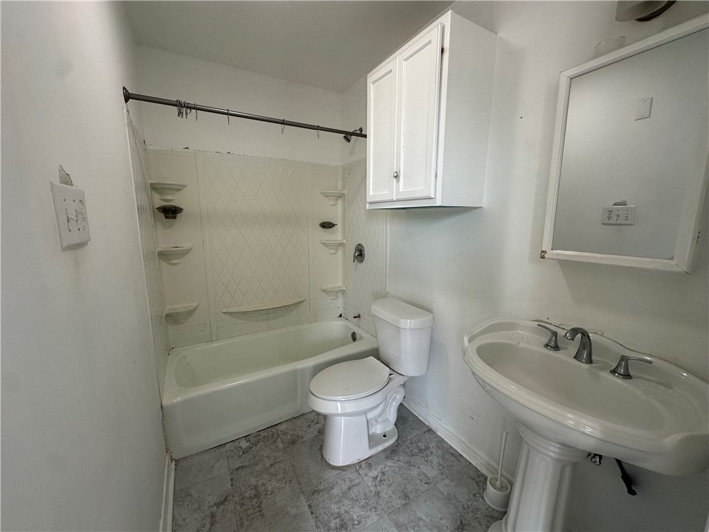 113 Lee Avenue Gregory, TX 78374 - Photo 11 of 22 a bathroom with a sink toilet and shower