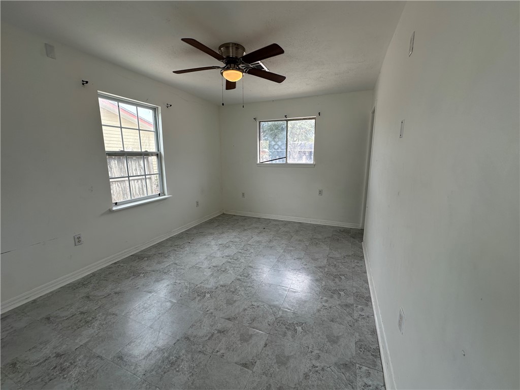 113 Lee Avenue Gregory, TX 78374 - Photo 12 of 22 an empty room with windows and fan