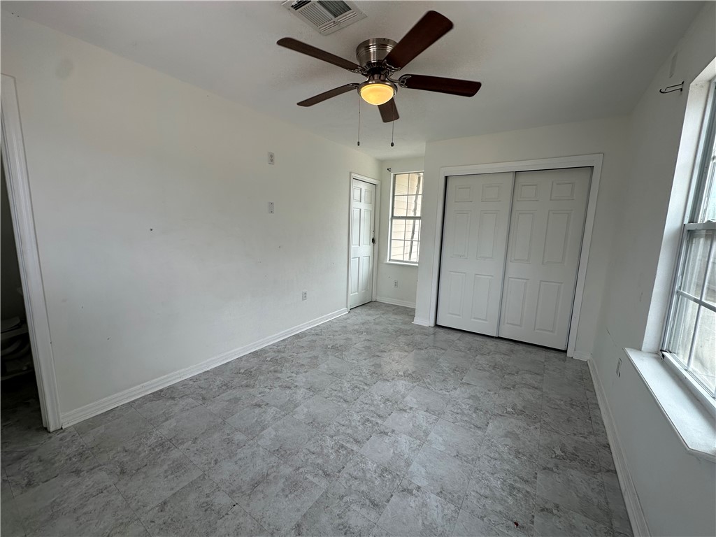 113 Lee Avenue Gregory, TX 78374 - Photo 15 of 22 an empty room with closet and windows