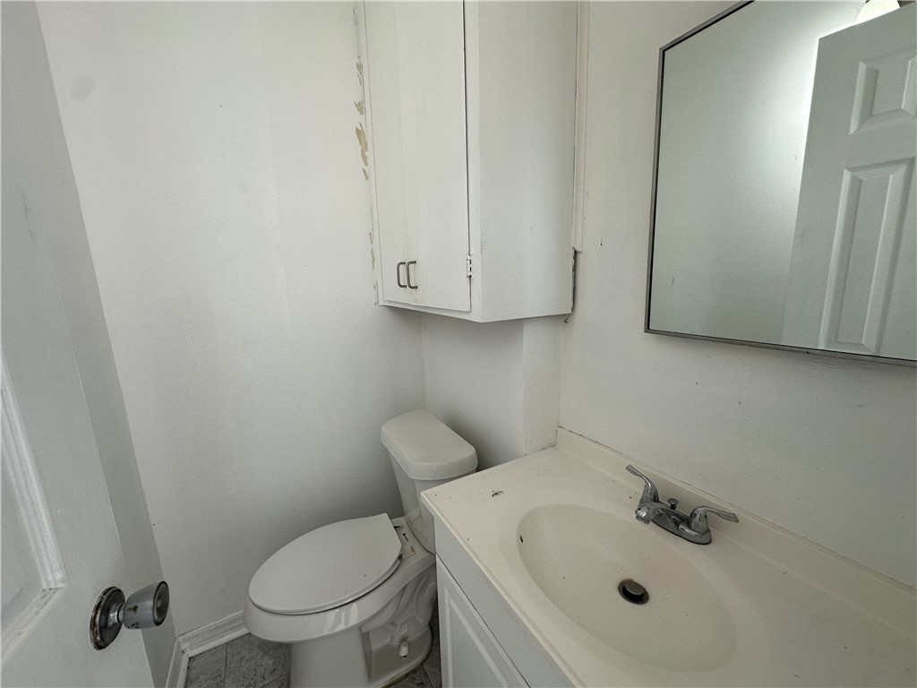 113 Lee Avenue Gregory, TX 78374 - Photo 16 of 22 a bathroom with a sink and a toilet