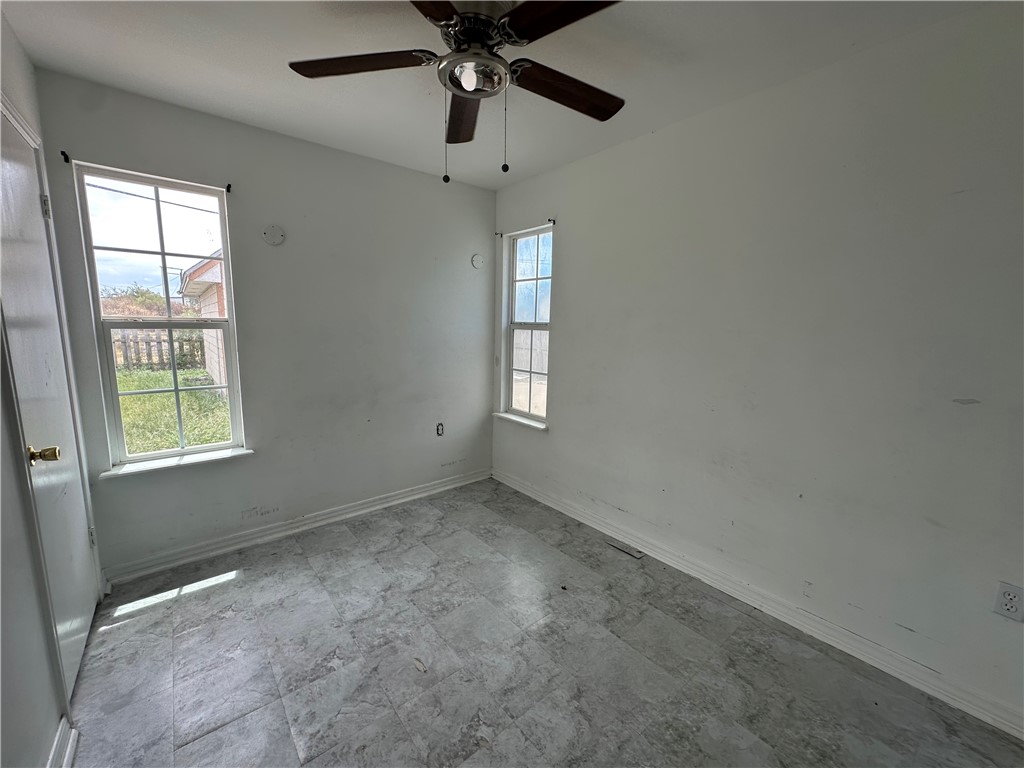 113 Lee Avenue Gregory, TX 78374 - Photo 17 of 22 an empty room with a window and a fan