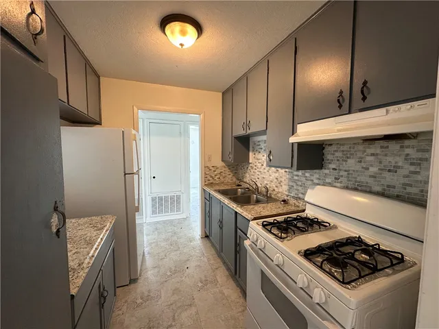 a kitchen with a stove and a sink