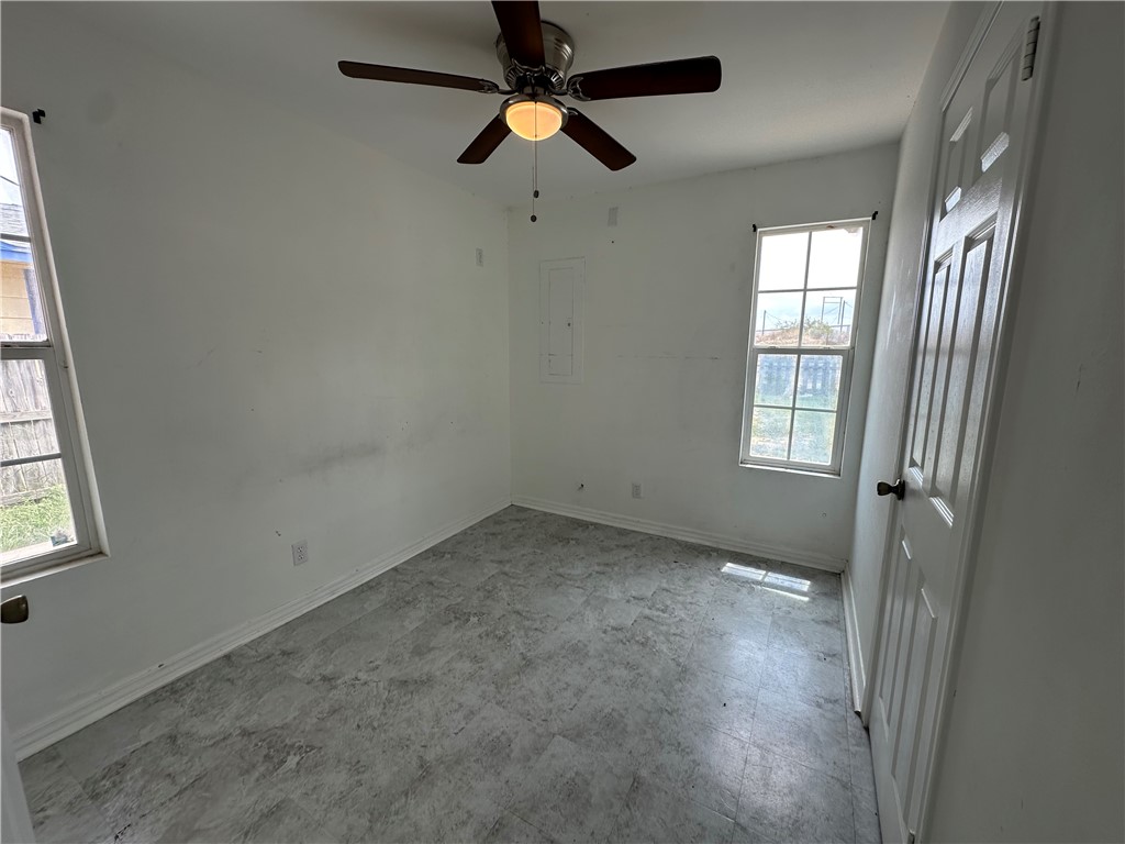113 Lee Avenue Gregory, TX 78374 - Photo 6 of 22 an empty room with windows and fan