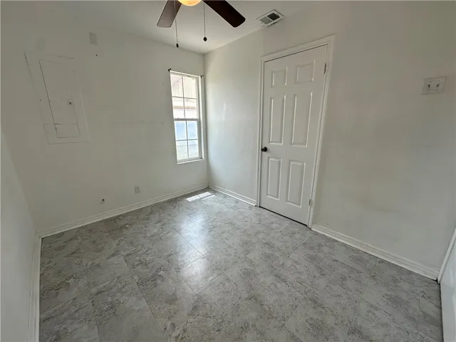 an empty room with windows and closet