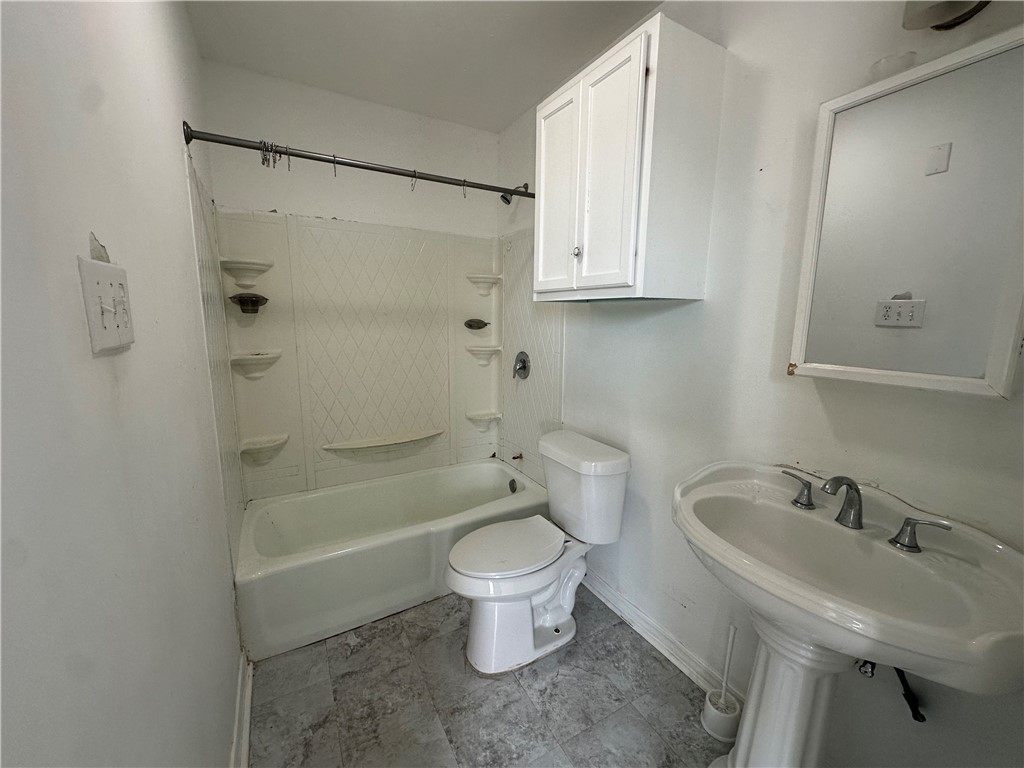 113 Lee Avenue Gregory, TX 78374 - Photo 10 of 22 a bathroom with a sink toilet and shower