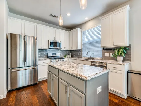 a kitchen with a refrigerator sink and microwave