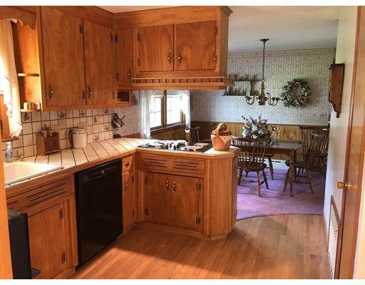 108 Woodland Road Springfield, MA 01129 - Photo 4 of 12 a kitchen with sink refrigerator dining table and chairs