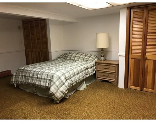 108 Woodland Road Springfield, MA 01129 - Photo 8 of 12 a bedroom with a bed and a lamp