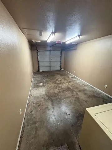 a view of a backyard with plants and large tree