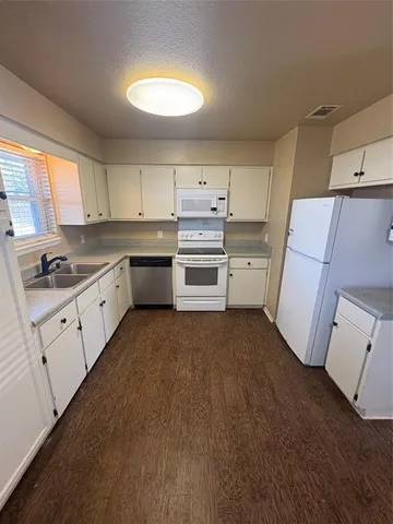 a kitchen with sink cabinets and window