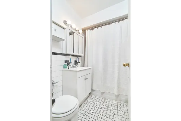 a kitchen with appliances a sink and cabinets