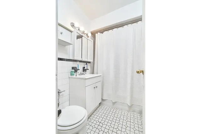 a kitchen with appliances a sink and cabinets