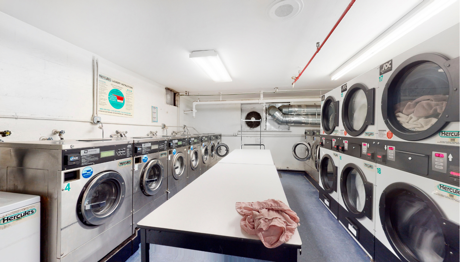 165 Christopher Street, Unit 2O Manhattan, NY 10014 - Photo 6 of 12 a utility room with dryer and washer