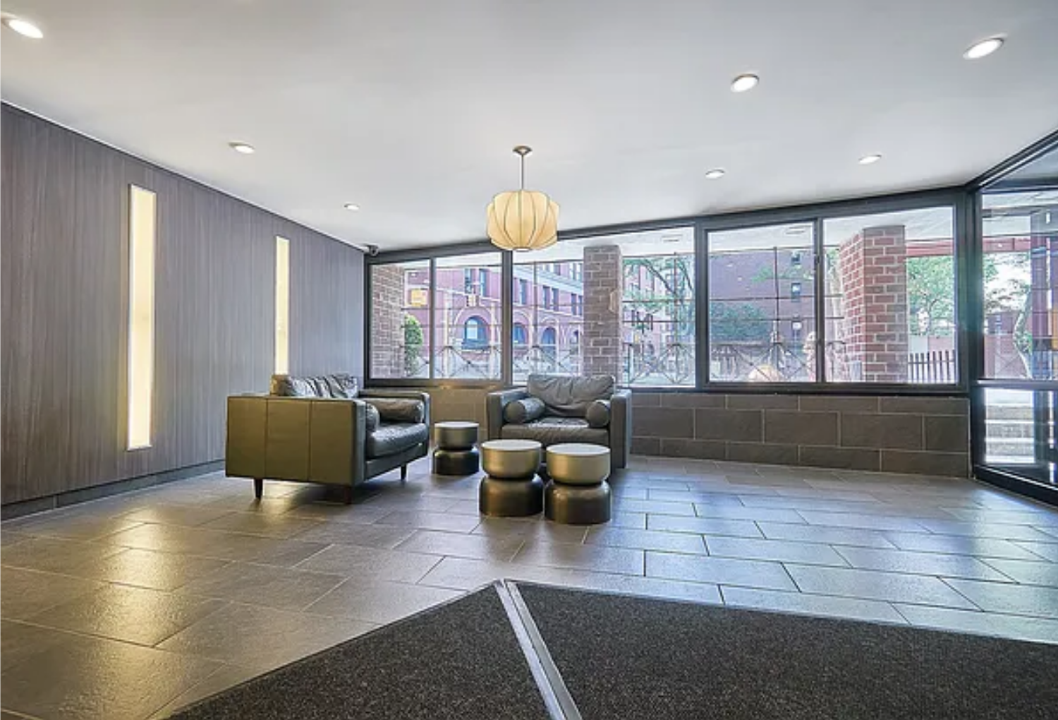 165 Christopher Street, Unit 2O Manhattan, NY 10014 - Photo 7 of 12 a living room with furniture and a floor to ceiling window