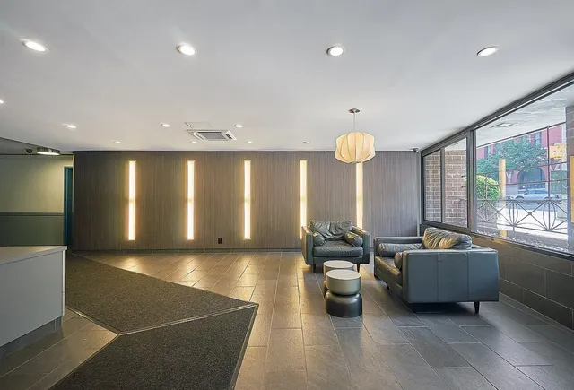 a living room with furniture and a floor to ceiling window