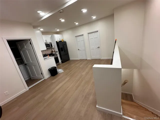 a view of a kitchen with furniture and wooden floor