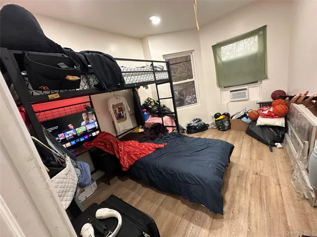 a bedroom with a bed and a mirror