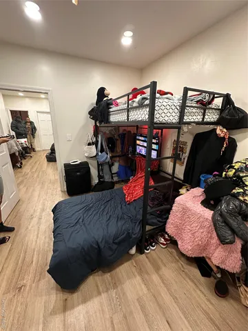a bedroom with furniture and a wooden floor