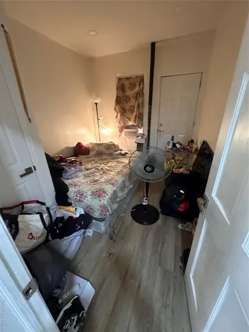 a view of a livingroom with wooden floor and staircase