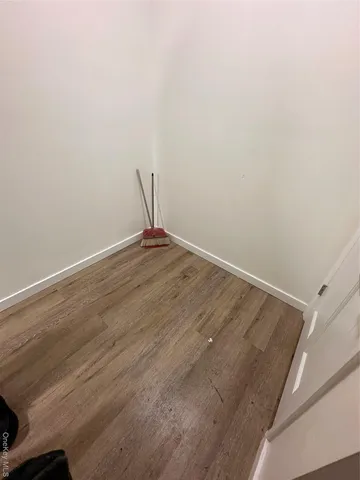 a living room with furniture hard wood floor and a window