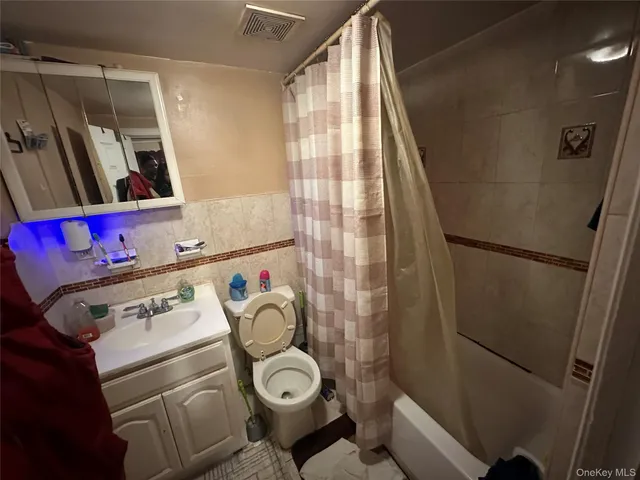 a bathroom with a sink toilet and shower curtain